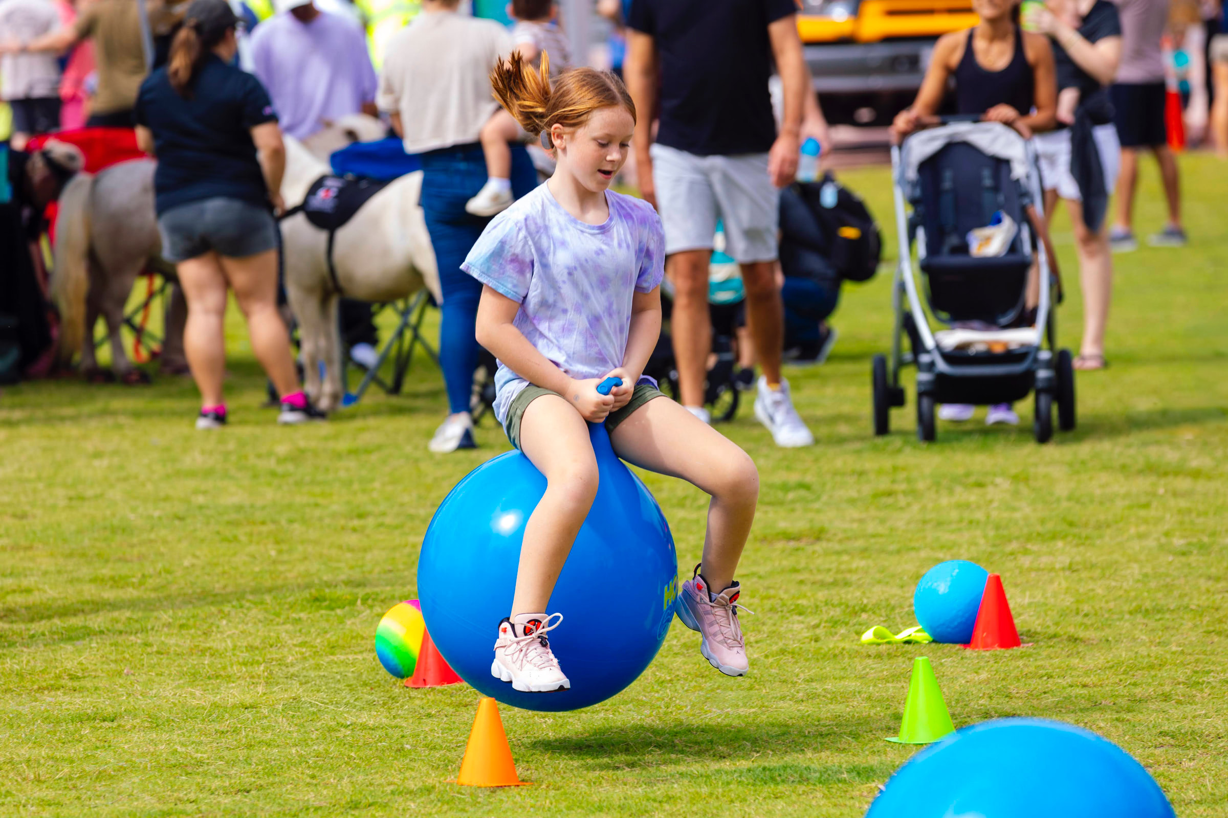 Child bouncing on ball
