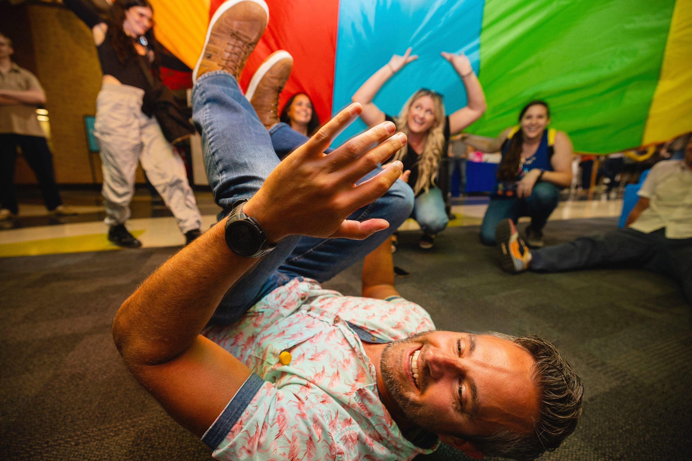 Parents playing under the rainbow tent