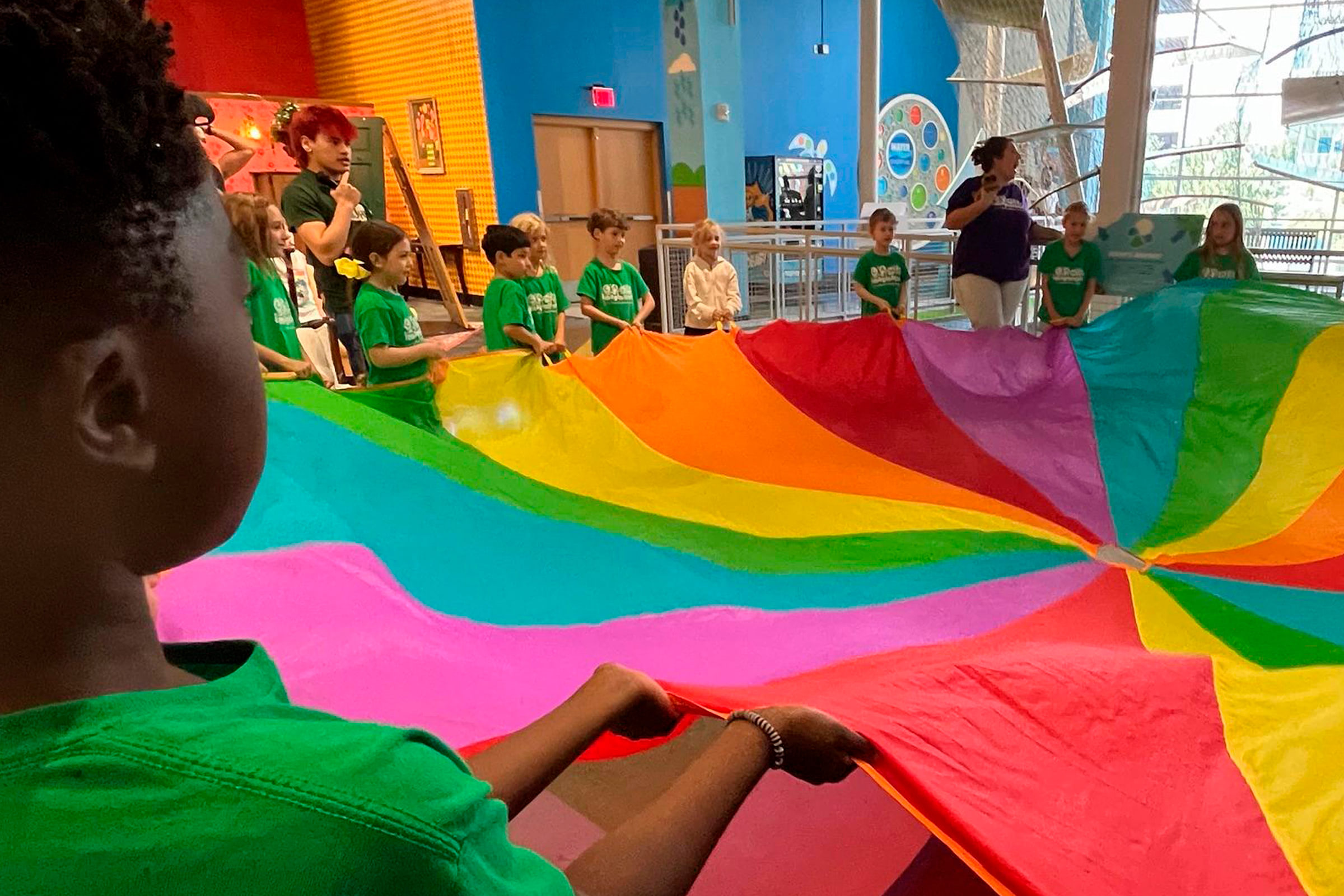 kids playing with colorful parachute