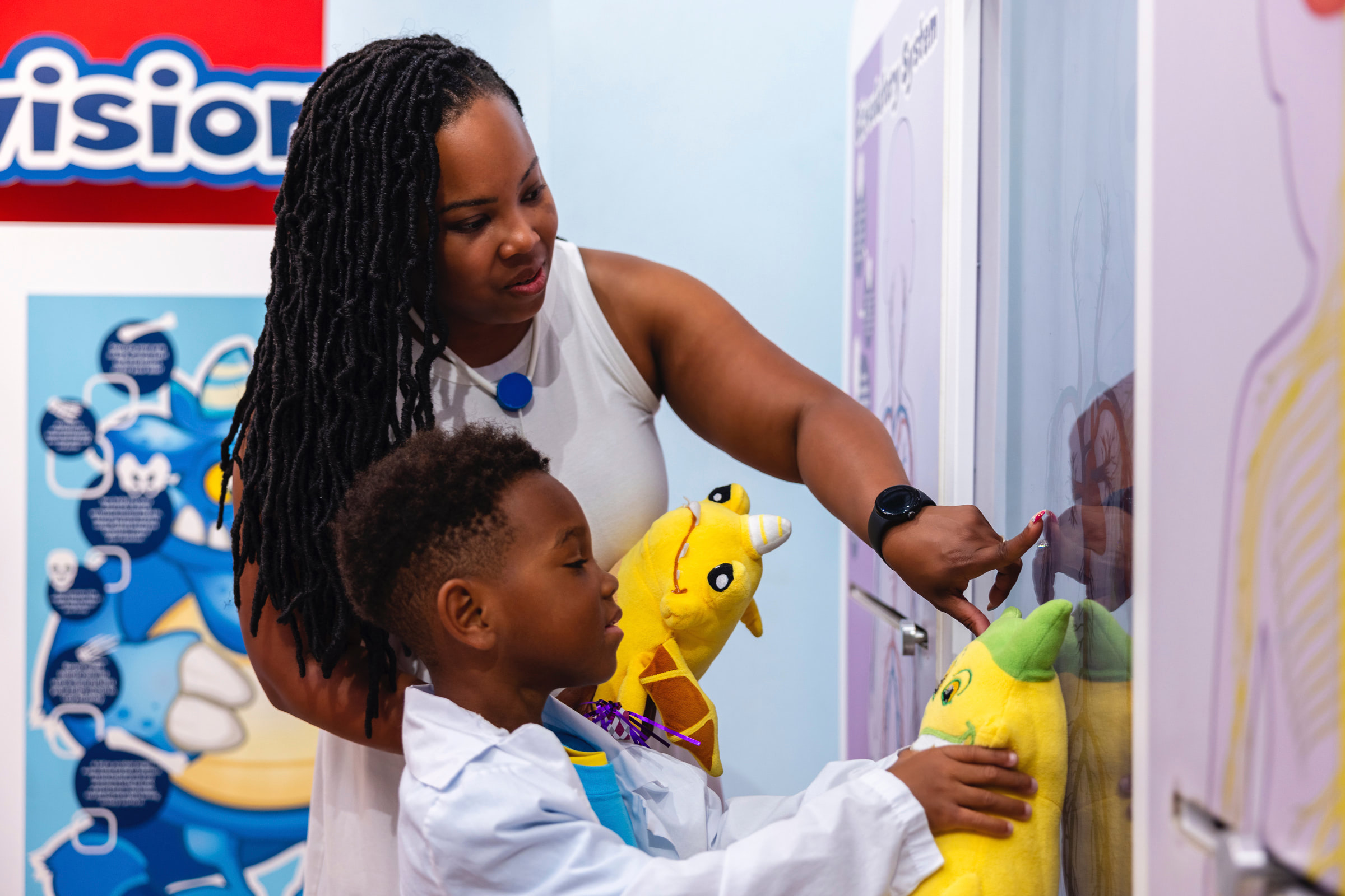 Mother and child playing with stuffed animals