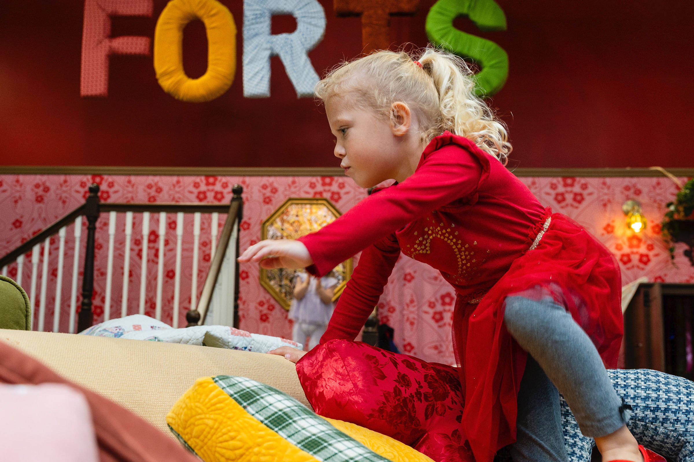 Child climbing on pillows