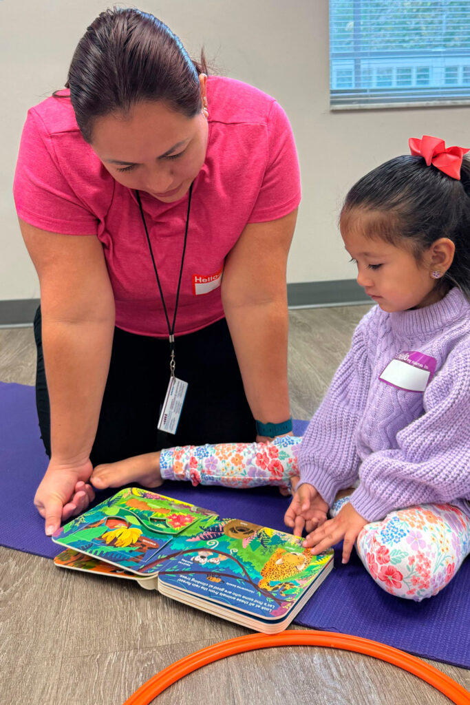 Volunteer reading a book to a child