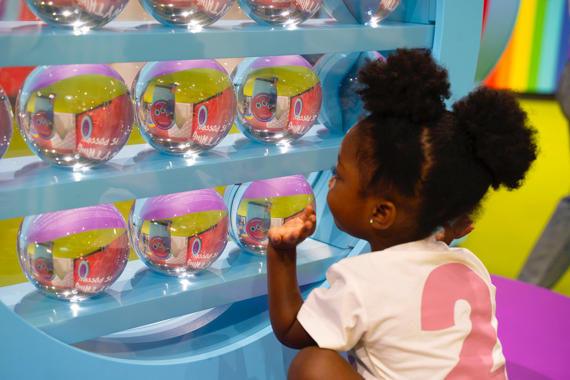 Child playing with glass orbs