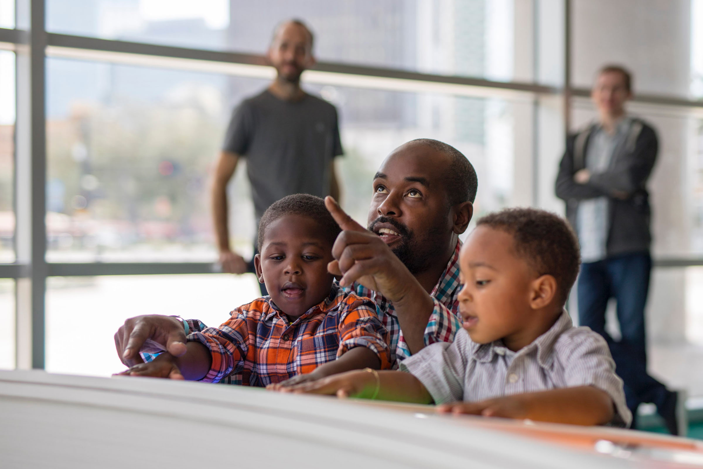 Dad playing with kids at an exhibit