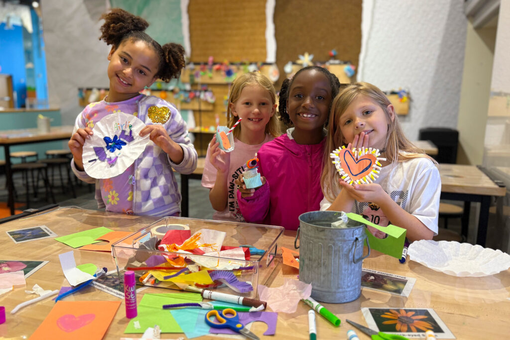 Group of four children making crafts at GCM