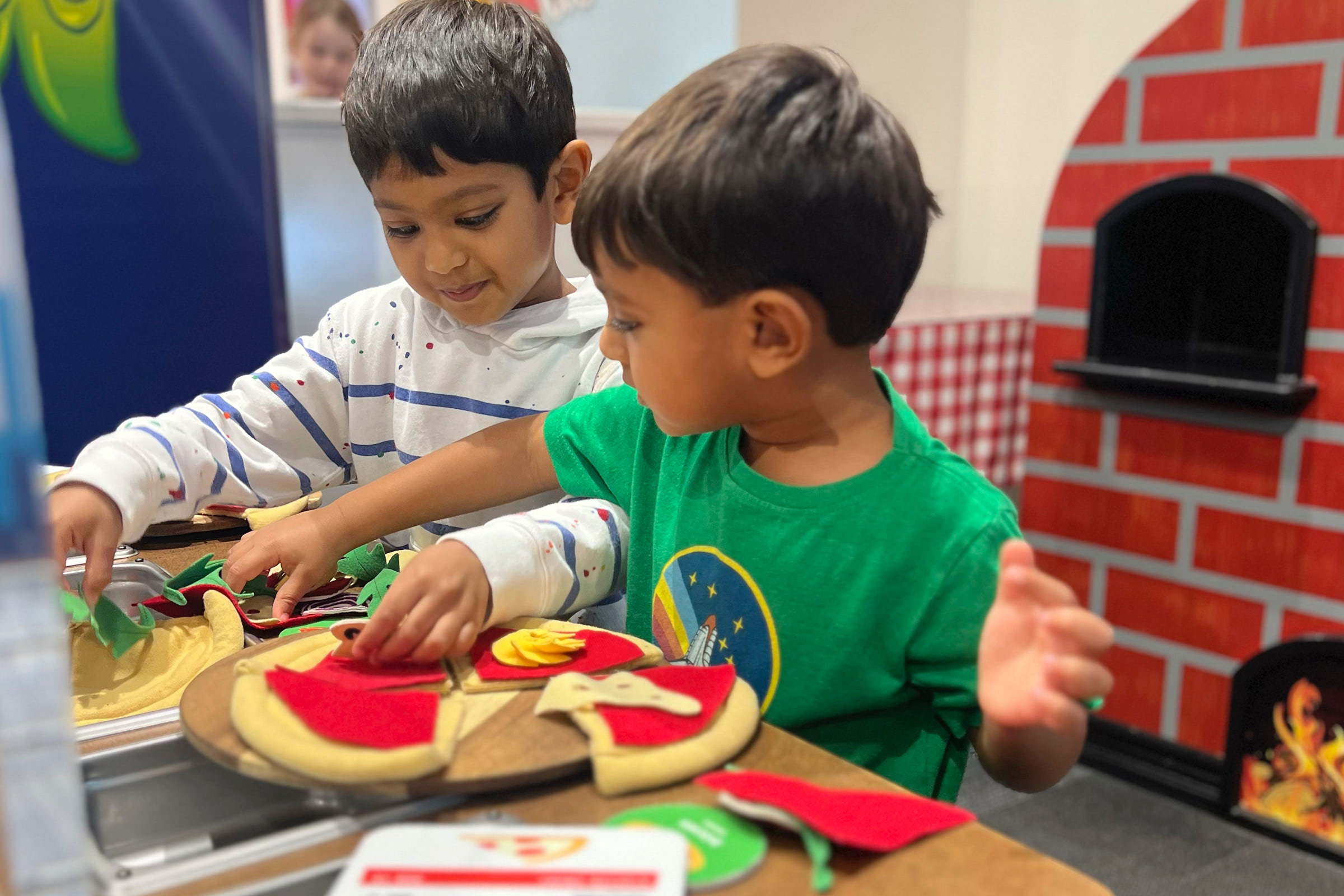 Young Children making pretend pizza at GCM
