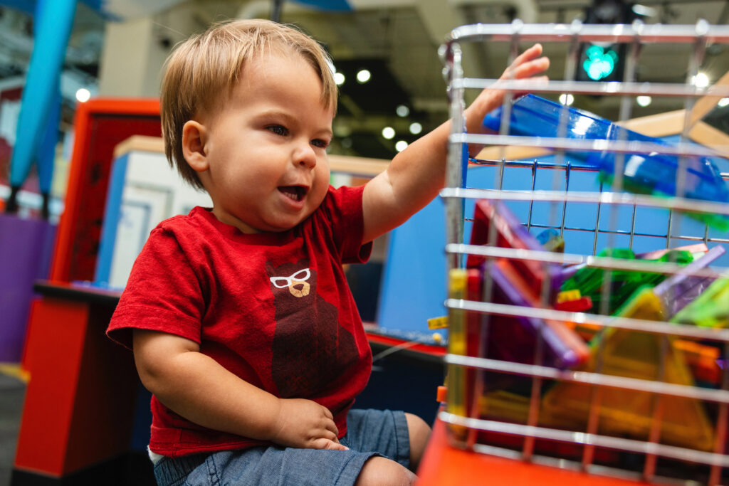 Toddler playing with basket of toys